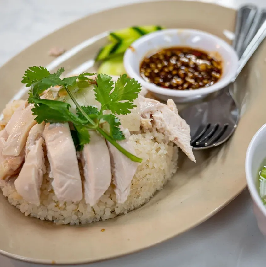 P Thai's Khao Man Gai signature dishes Khao Man Gai (poached or fried), Khao Kha Moo (braised pork leg)
